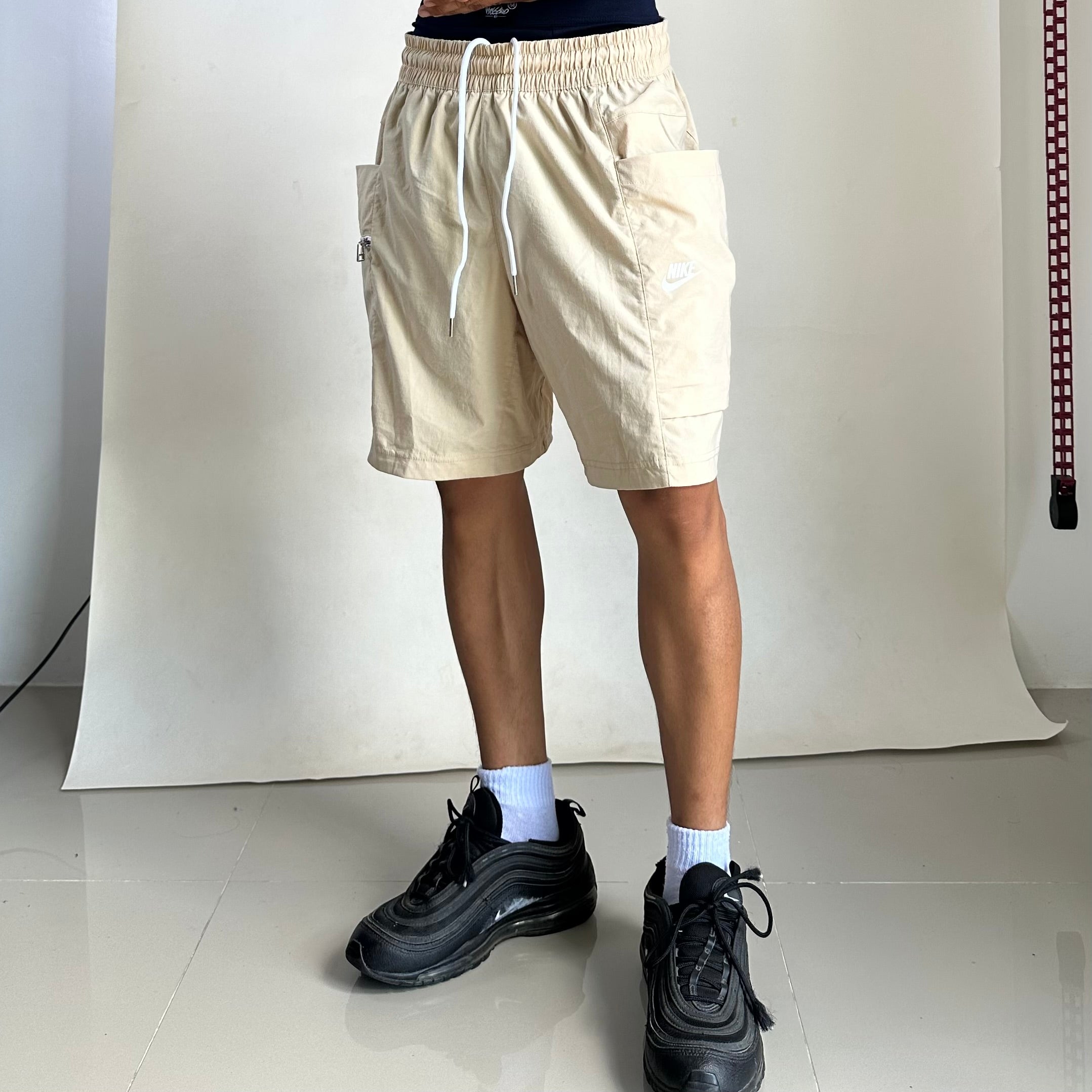 Nike Men’s Sportswear Woven Cargo shorts in a beige color featuring a zippered utility pocket (Size 32-36)
