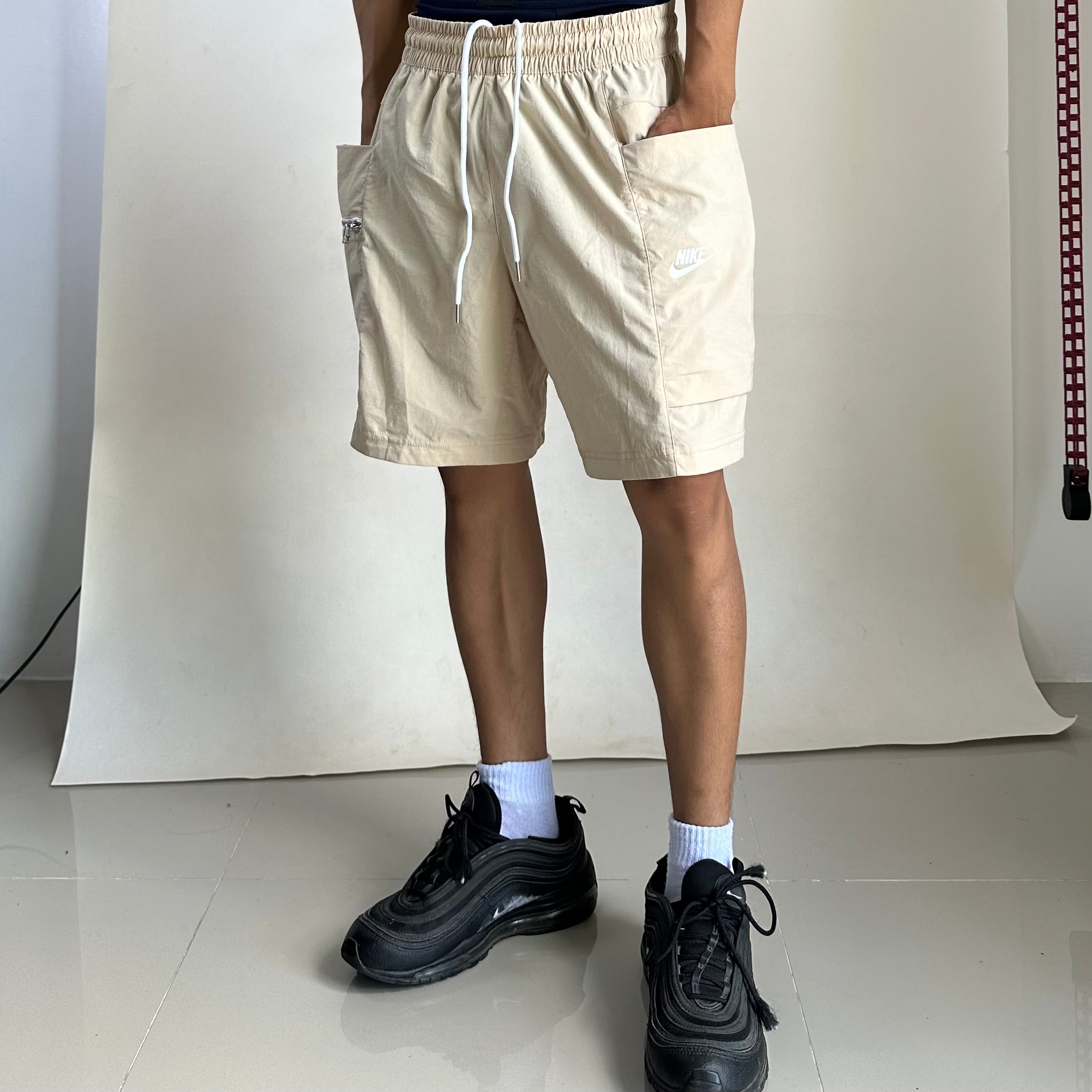 Nike Men’s Sportswear Woven Cargo shorts in a beige color featuring a zippered utility pocket (Size 32-36)